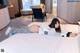 A woman laying on a bed in a hotel room.