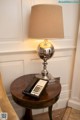 A table with a lamp and a telephone on it.