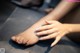 A woman's feet with a pair of black stockings on them.