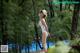 A woman in a white bathing suit and a straw hat.