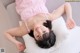 A woman laying on a pillow on a couch.