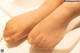 A close up of a woman's feet in a bathtub.