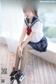 A woman in a school uniform sitting on a window sill.