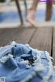 A pair of blue jeans sitting on top of a wooden table.