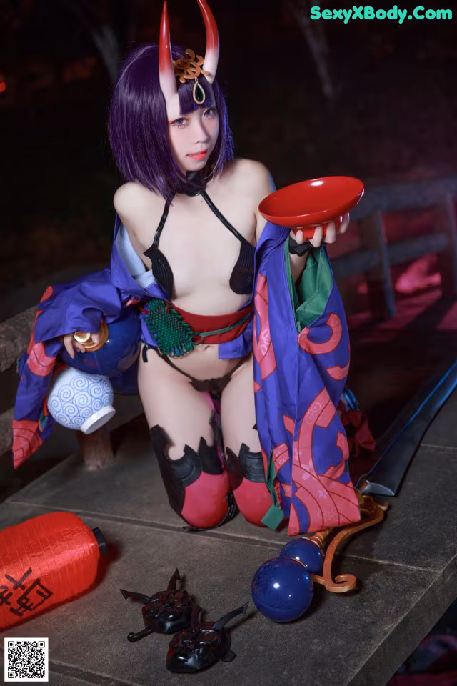 A woman in a kimono holding a red bowl and a sword.